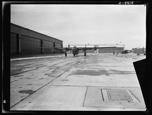 Production. B-24E (Liberator) bombers at Willow Run. A new B-24E (Liberator) bomber just returned from a successful trial flight taxis down a runway at Ford's big Willow Run plant. The Liberator is capable of operation at high altitudes and over great ranges on precision bombing missions. It has pro