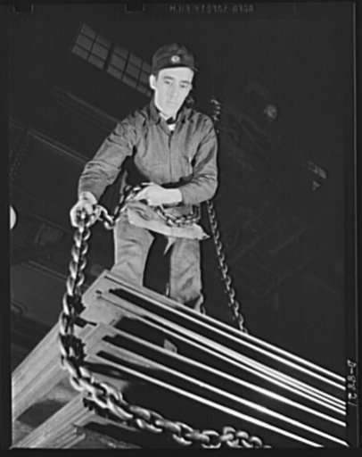 Production. Halftrac armoured cars. Attaching a chain sling to a lift of steel plates for the production of halftrac scout cars in a converted Eastern lock and safe plant. Diebold Safe and Lock Company, Canton, Ohio