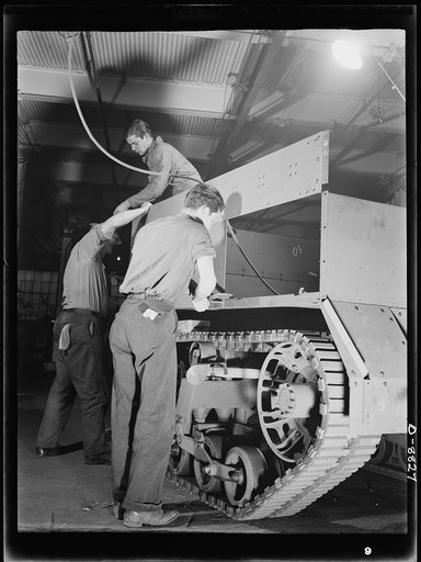 Production. Halftrac armoured cars. Attaching body parts to a halftrac scout car in the converted Eastern plant of a lock and safe manufacturer. Diebold Safe and Lock Company, Canton, Ohio