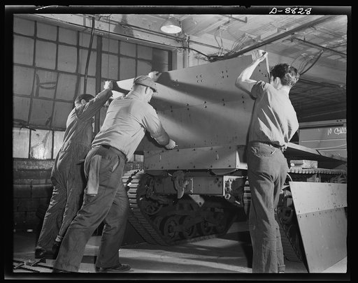Production. Halftrac armoured cars. Attaching body parts to a halftrac scout car in the converted Eastern plant of a lock and safe manufacturer. Diebold Safe and Lock Company, Canton, Ohio