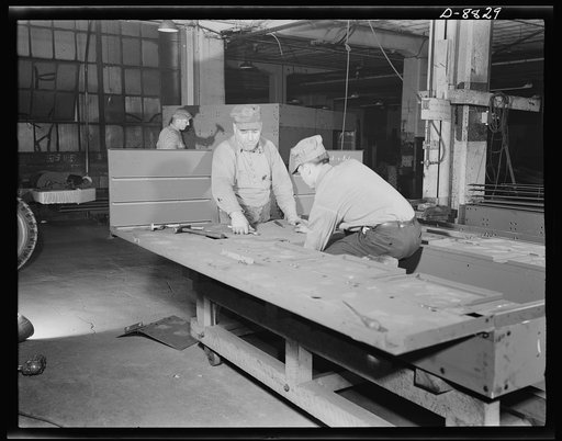 Production. Halftrac armoured cars. Attaching body parts to a halftrac scout car in the converted Eastern plant of a lock and safe manufacturer. Diebold Safe and Lock Company, Canton, Ohio