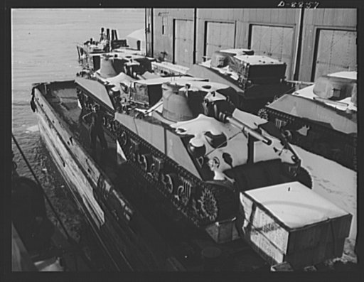 Transportation. Lend-lease shipments. American M-4 tanks on a barge alongside a United Nations freighter that will carry them together with food and other war necessities, as part of a lend-lease shipment to one of our allies