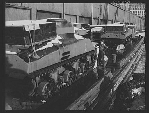 Transportation. Lend-lease shipments. American M-4 tanks on a barge alongside a United Nations freighter that will carry them together with food and other war necessities, as part of a lend-lease shipment to one of our allies