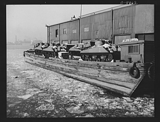 Transportation. Lend-lease shipments. American M-4 tanks on a barge alongside a United Nations freighter that will carry them together with food and other war necessities, as part of a lend-lease shipment to one of our allies
