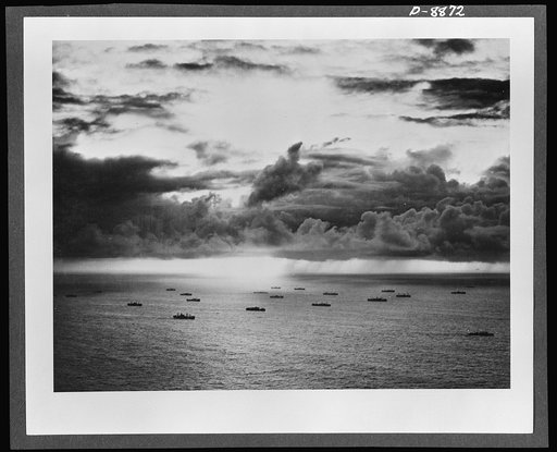 Convoy. Silhouetted against a tropical sky, an American convoy plods steadily across the broad Pacific. Ships like these and the naval vessels and planes that protect them are maintaining the "bridges of boats" that link us with our far-flung battle fronts