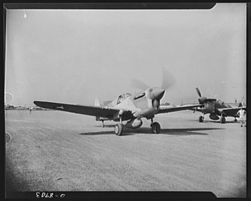 American "steam chickens" arrive in Africa. Unpacked, assembled and given its test flight, a P-40 fighter plane is now to take off for battle. Only four hours before, she was taken from the hold of a cargo ship at an African port