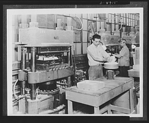 Plastic tableware for the Navy. Durable plastic tableware, designed to replace china and aluminum dishes used on naval vessels, is made of impregnated fabric molding material. Here the operator weighs out the correct amount of material for a molding operation as shown in the press at the left