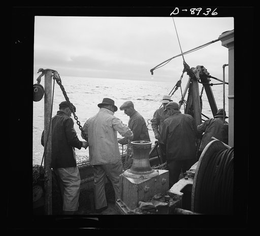 Victory food from American waters. At sunset fishermen mend nets torn by rocks on the ocean floor. A shortage of linen twine and Manila hemp needed for nets is only one of the war-time difficulties fishermen today must face