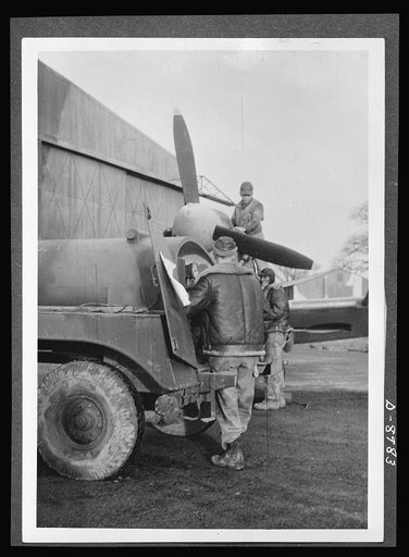 Reciprocal aid. British equipment plays an important part in supplying U.S. Army Air Forces in Britain. Here a British "Bowser" staffed by American airmen is used for refueling a plane