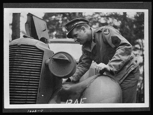 Reciprocal aid. Sergeant F.D. O'Neal of Chicago, serving with the American air forces in England, makes a motor adjustment on a British Vauxhall. The automobile is part of the supplies and services furnished American forces under British Reciprocal Aid Program