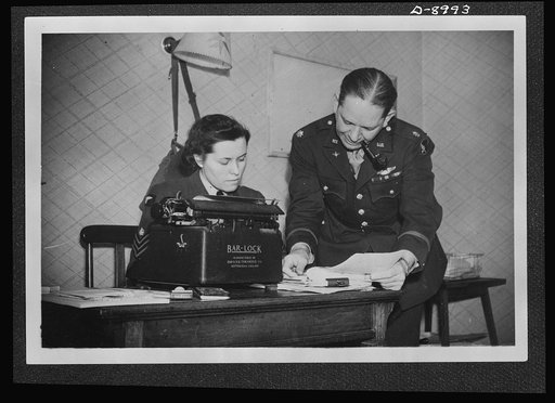 Reciprocal aid. With the American air forces in Britain. Lieutenant Colonel W. H. Stovall, of Stovall, Mississippi, has a WAAF (Women's Auxiliary Air Force) flight sergeant as his secretary. The British typewriter shown in his office is one of the many items of supplies and equipment provided Americ