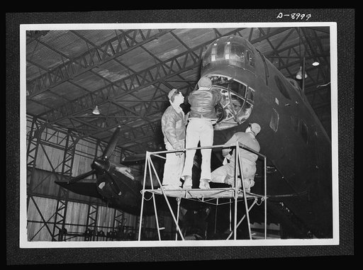 Reciprocal aid. An American crew at work on a British Halifax four-engined bomber evidence of the close cooperation between British and U.S. forces in Britain. U.S. ground technicians as well as fighter squadrons, are working with members of the Royal Air Force (RAF) and the Women's Auxiliary Air Fo