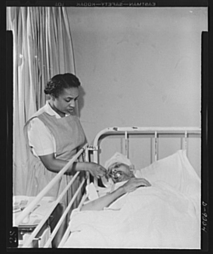 Answering call for volunteer nurses aides. Volunteer nurses aides help to relieve the shortage in graduate nurses by assisting in the feeding of patients as well as in making beds, giving baths, taking temperatures, pulse, respiration, etc. Photo shows Mrs. Thomas Couch, volunteer nurses aide, feedi
