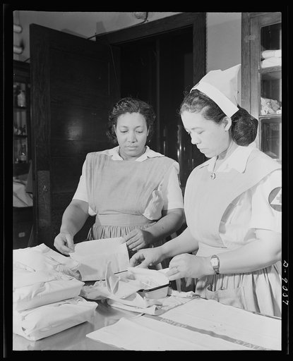 Answering call for volunteer nurses aides. The central dressing room at Freedmen's Hospital, Washington, D.C., Mrs. Ethel Washington and Mrs Louise Beleno, senior aide, packing surgical kits as part of work of volunteer nurses aide class. These volunteers help relieve the shortage of graduate nurses
