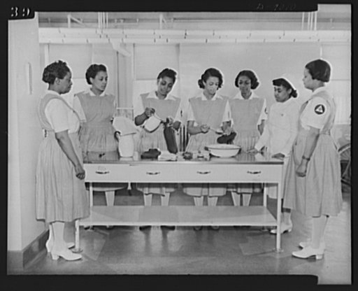 Answering call for volunteer nurses aides. One phase of training for the volunteer nurses aides at Freedmen's Hospital, Washington, D.C.  Miss Thelma Harris, staff nurse, is shown instructing uncapped students on how to fill hot water bottles and ice caps. Left to right: Miss Florence Jackson, Mrs. 