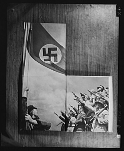 Axis propaganda. The lavishness of Nazi propaganda is illustrated by this book which Elmer Davis, director of the Office of War information, displayed at his press conference on March 6, 1943. After the book is opened at this place, the left page may be opened upward revealing the flag. The picture 