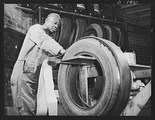 Tire recapping. Recapping a worn passenger car tire. Reclaimed camelback rubber is applied after the old tread surface of the tire has been ground down evenly and coated with rubber adhesive. The plan to recap passenger tires with reclaimed rubber camelback, approved by rubber director William M. Je