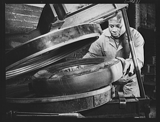 Tire recapping. A recap job on a passenger car tire. The tire with a tread strip of reclaimed camelback rubber is put into a curing mold. The old tread surface had previously been ground down evenly and coated with rubber adhesive. The plan to recap passenger tires with reclaimed rubber camelback, a
