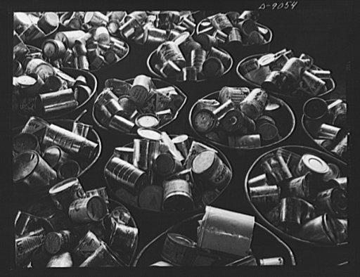 Conversion. Rendering of household fats. Cans of waste fats collected from America's kitchens come to a rendering plant in large steel drums. Note that the cans of various sizes and with or without covers, are mostly coffee and shortening cans now unavailable to many housewives. Any type of clean ca