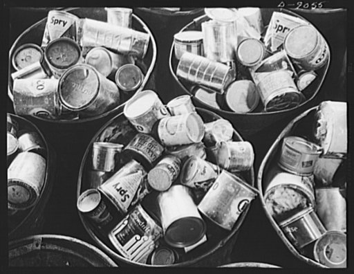 Conversion. Rendering of household fats. Cans of waste fats collected from America's kitchens come to a rendering plant in large steel drums. Note that the cans of various sizes and with or without covers, are mostly coffee and shortening cans now unavailable to many housewives. Any type of clean ca