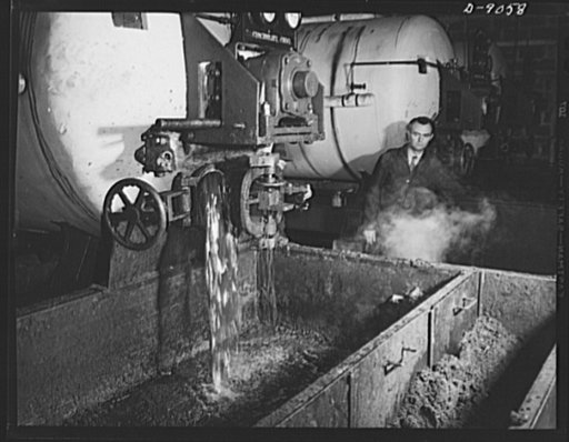Conversion. Rendering of household fats. Reclaimed household greases from America's kitchens drain into an open vat at a rendering plant. Some of the batches are recooked with additional fats to bring them up to certain specific grades