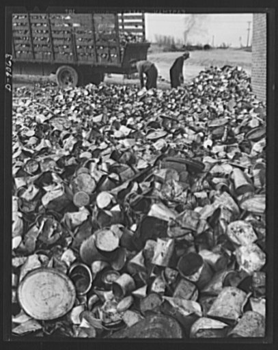 Conversion. Rendering of household fats. Huge quantities of tin cans are reclaimed at a fat rendering plant for forwarding to a detinning plant.  These cans come to the rendering plant filled with reclaimed household fats
