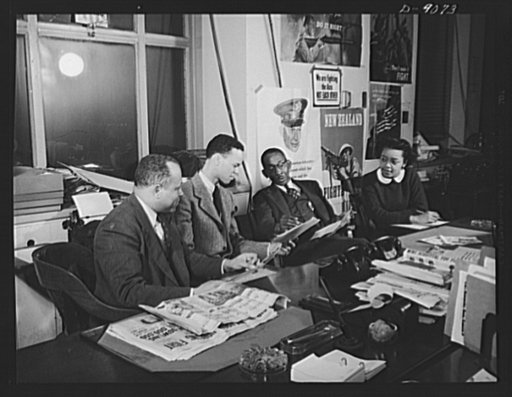 Office of War Information news bureau. Besides supplying war news from all government agencies to 240 Negro papers each week, Ted Poston, editor of the OWI's Negro desk in Washington, selects picture sequences of special interest to the Negro press. He is shown working with photographer Roger Smith 