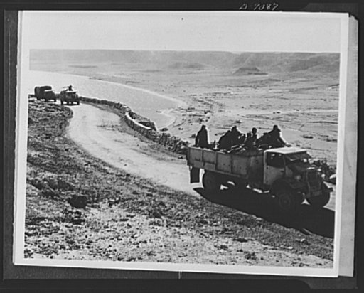 8th Army in Tripoli. Lumbering up the hills near Salum in North Africa, truckloads of British 8th Army soldiers move westward into Tunisia in the early part of the Tripoli campaign