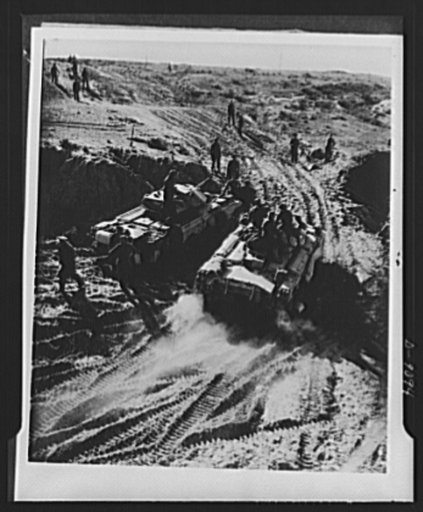 8th Army in Tripoli. Tanks track through the muddy sea, which was the road the British 8th Army took between Homs and Tripoli campaign
