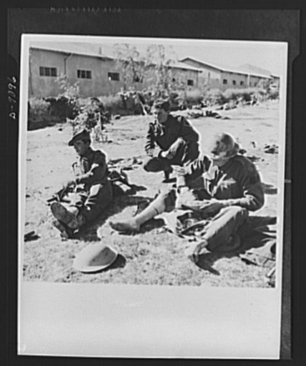 8th Army in Tripoli. Time out on the road to Tripoli for a veteran tank crew of the British 8th Army. One soldier takes care of sore feet, a common army complaint