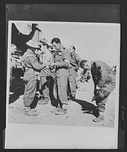 8th Army in Tripoli. Time out on the road to Tripoli for a veteran tank crew of the British 8th Army. The Medical Corps opens shop during the rest to take care of minor casualties of the journey