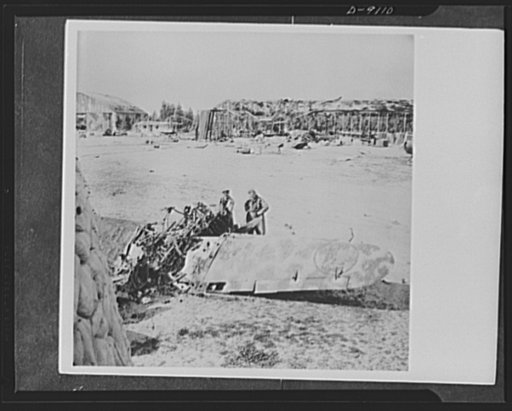 8th Army in Tripoli. Wreckage of Italian hangars and airplanes at Castel Benito Airfield outside Tripoli. The airfield was captured by the British in the Tripoli campaign