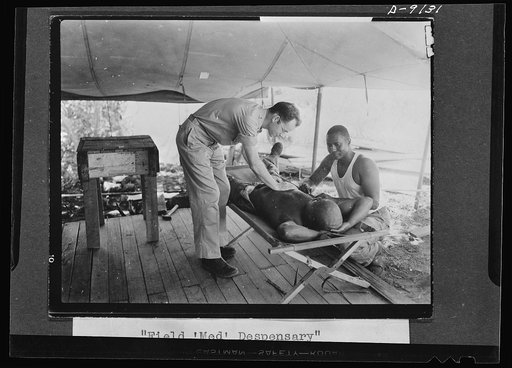 U.S. Negro troops in New Guinea. Medical care is well provided for all American and allied forces in New Guinea. Here a field medical dispensary is set up and operated by a Negro medical detachment. Soldiers go daily for "sick calls" and any possible illness is checked or given immediate care