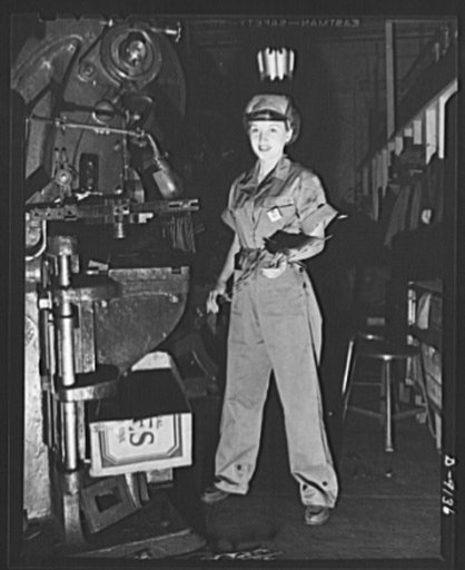 Madelon O'Leary operates a punch press in a well-cut, one-piece overall. Trim--and plenty of room for action. Visor-front cap completely covers hair for safety and essential neatness