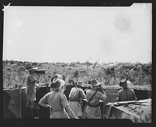 African natives prepare for air attack. Guarding against possible enemy attacks in Africa, crack veterans of the Battle of Britain are instructing African natives in anti-aircraft units. In the foreground, officers in the command post keep their eyes on the target as the gun immediately ahead of the
