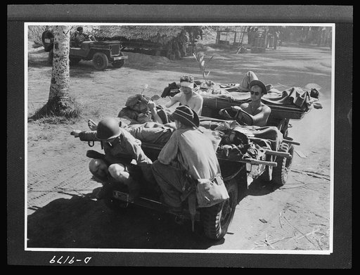 Australia in the war. An American jeep serves as an ambulance for Australian troops in New Guinea. The versatile little car carries wounded men on stretchers back to the base