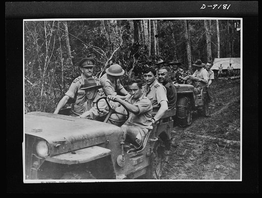 Troops in Australia. American jeeps carried Australian military chiefs and cabinet ministers in a recent visit to battle areas in New Guinea. Air Vice-Marshall G. Jones is shown in the leading vehicle during the tour of the convoy