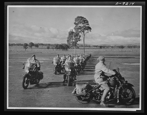 Australia in the war. Australian military police, astride American motorcycles, stages a demonstration for distinguished visitors at a camp in Australia. They have been commended both in authoritative circles and among the troops for their magnificient work in the Middle East campaigns