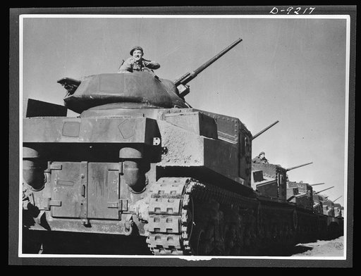 Australia in the war. American medium tanksand their Anzac crews lined up for review at a camp in Australia. Along with other lend-lease equipment, these tanks are helping in the development of a formidable Australian mechanized army