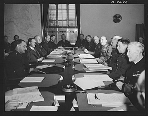 Combined Munitions Assignments Board. Combined Munitions Assignments Board weekly session in Washington. At conference table left to right are: Major General L.D. Clay (American); Harry Hopkins (American); Major General J.H. Burns (American); Lieutenant Colonel E.C. Kielkopf (American); Wing Command