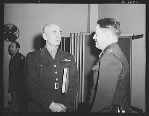 Combined Munitions Assignments Board. Major General J. H. Burns, executive officer of the Combined Munitions Assignments Board, confers with staff member Colonel John B. Franks
