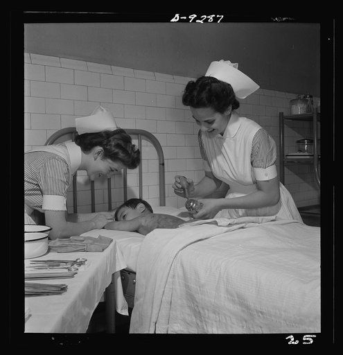 Nurse training. Nurses learn the care of patients suffering from burns. Here, the nurse paints a boy's burned back with sulfathiasol. The treatment of burns is of much public interest in these days of warfare on civilian populations with incendiary bombs