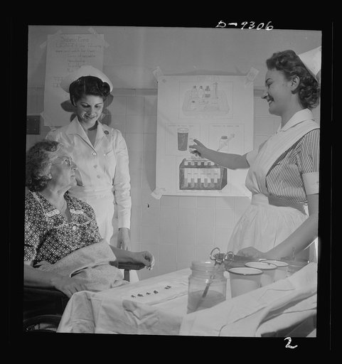 Nurse training. A student nurse explains to diabetic patient how orange juice in her diet can limit sugar to the proper amount. In this type of work student nurses relieve graduate nurses for military duty