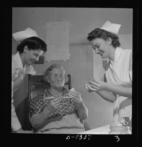 Nurse training. A student nurse (right) instructs a patient in the method of measuring her own insulin dose as a supervisor observes