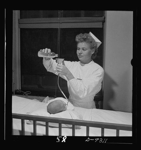 Nurse training. A nurse gives this weak infant its meal through the Gavage method