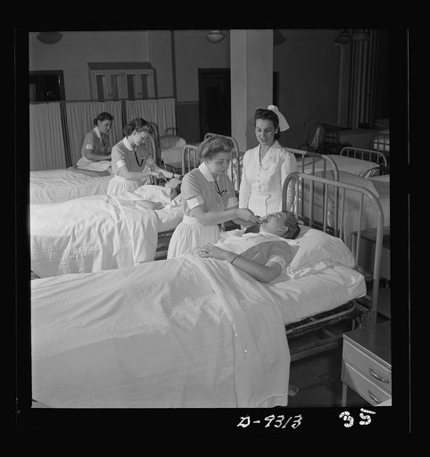 Nurse training. First-year students practice various sick-room techniques on one another. They will soon be ready for work in the wards
