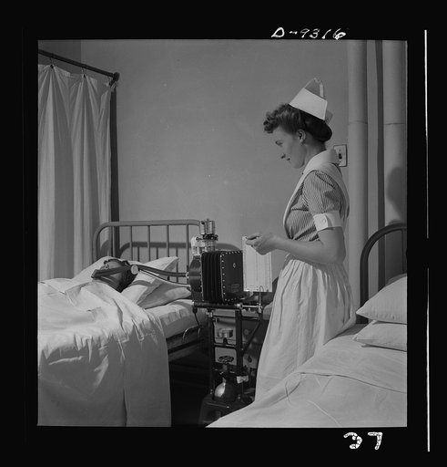 Nurse training. A student nurse gives a patient a metabolism test