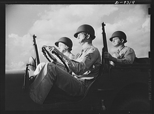 Fort Myer, Virginia. Alert and ready for action are these rough-riding, hardboiled members of a jeep crew at Fort Myer, Virginia. Properly equipped with new type helmet and Garand rifles, these soldiers of Uncle Sam's armoured forces typify the ruggedness and determination of the American fighting m