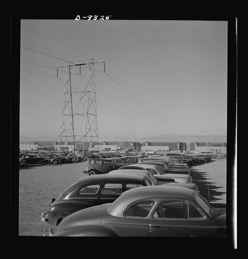 Production. Magnesium. Workers' cars parked under a section of the high-tension transmission lines which bring electrical power to Basic Magnesium's huge plant in the southern Nevada desert