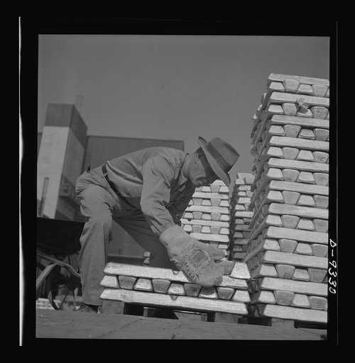 Production. Magnesium. Enormous asbestos mittens must be worn by men handling the thousands of hot magnesium ingots produced daily at Basic Magnesium's giant plant in the southern Nevada desert. A number of units of this plant are now in production. Full operation is scheduled for the summer of 1943